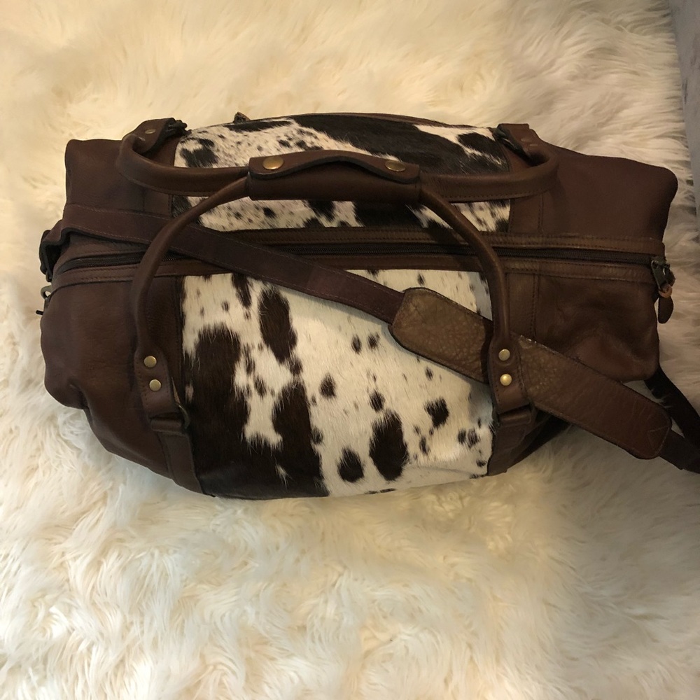 brown leather duffle bag with cow hide